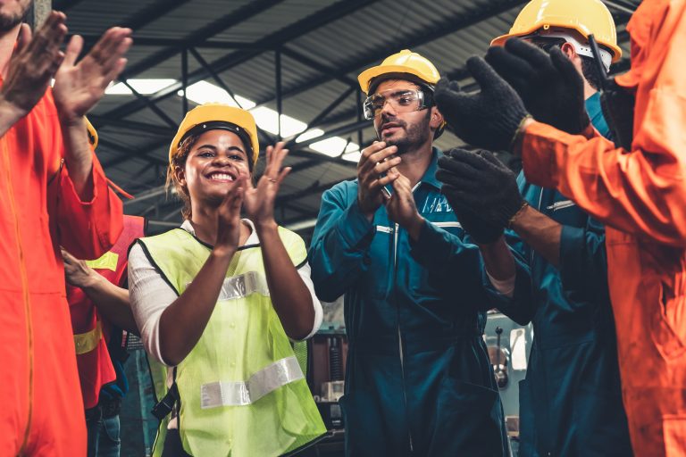 Skillful worker celebrate success in the factory
